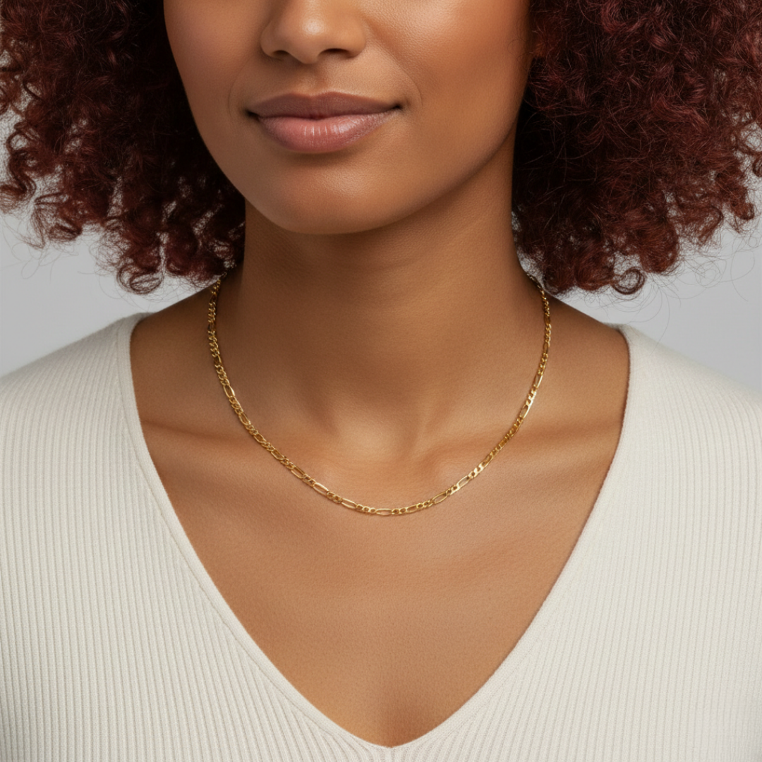 Woman wearing a gold necklace against a neutral background