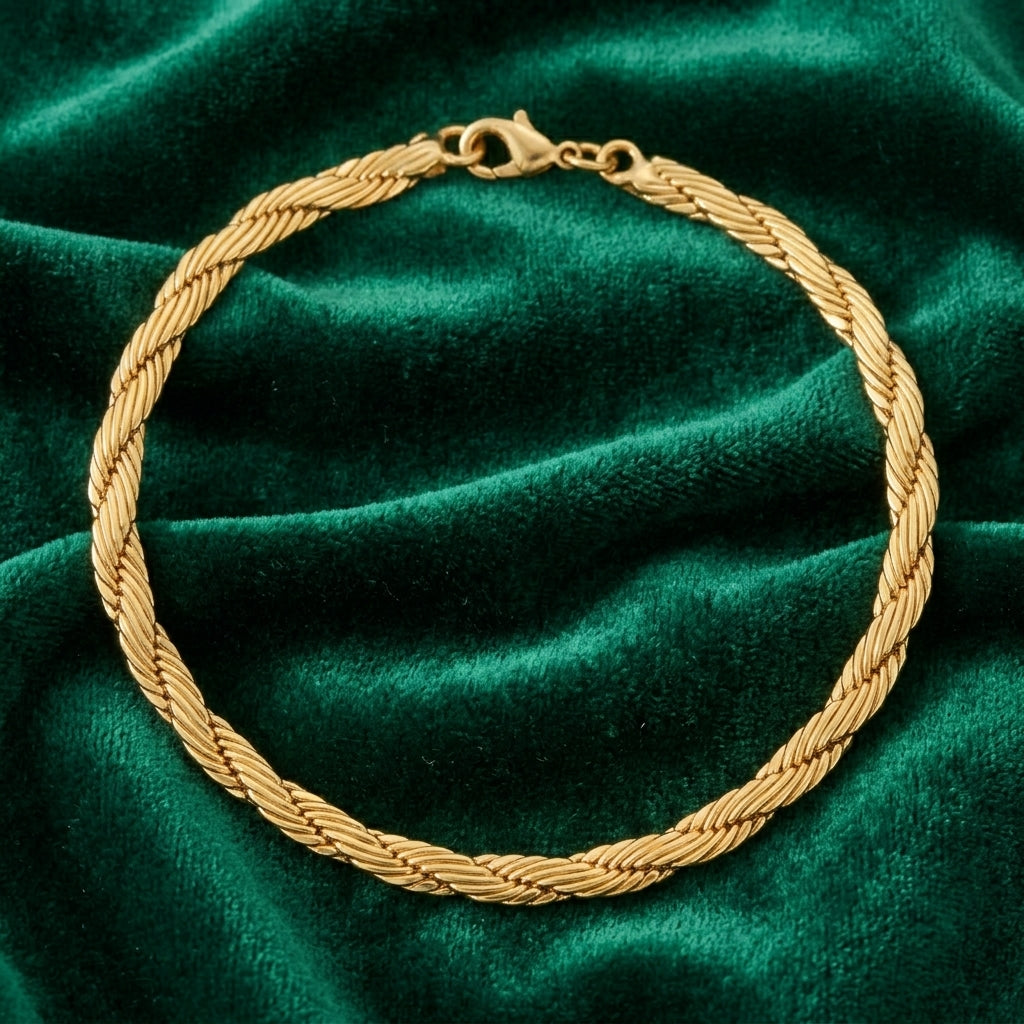 Gold Cobra Chain Bracelet on a green velvet background