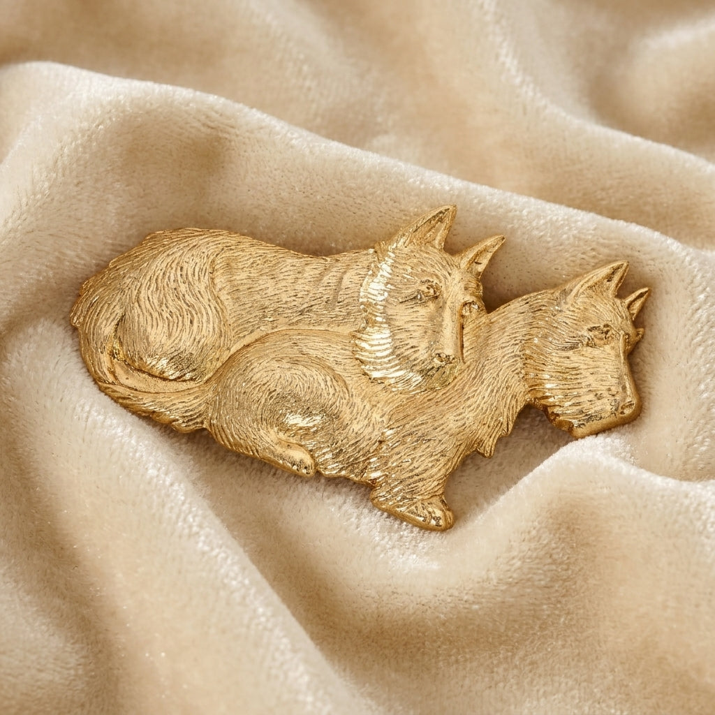 Gold dog-shaped terrier brooch on beige fabric