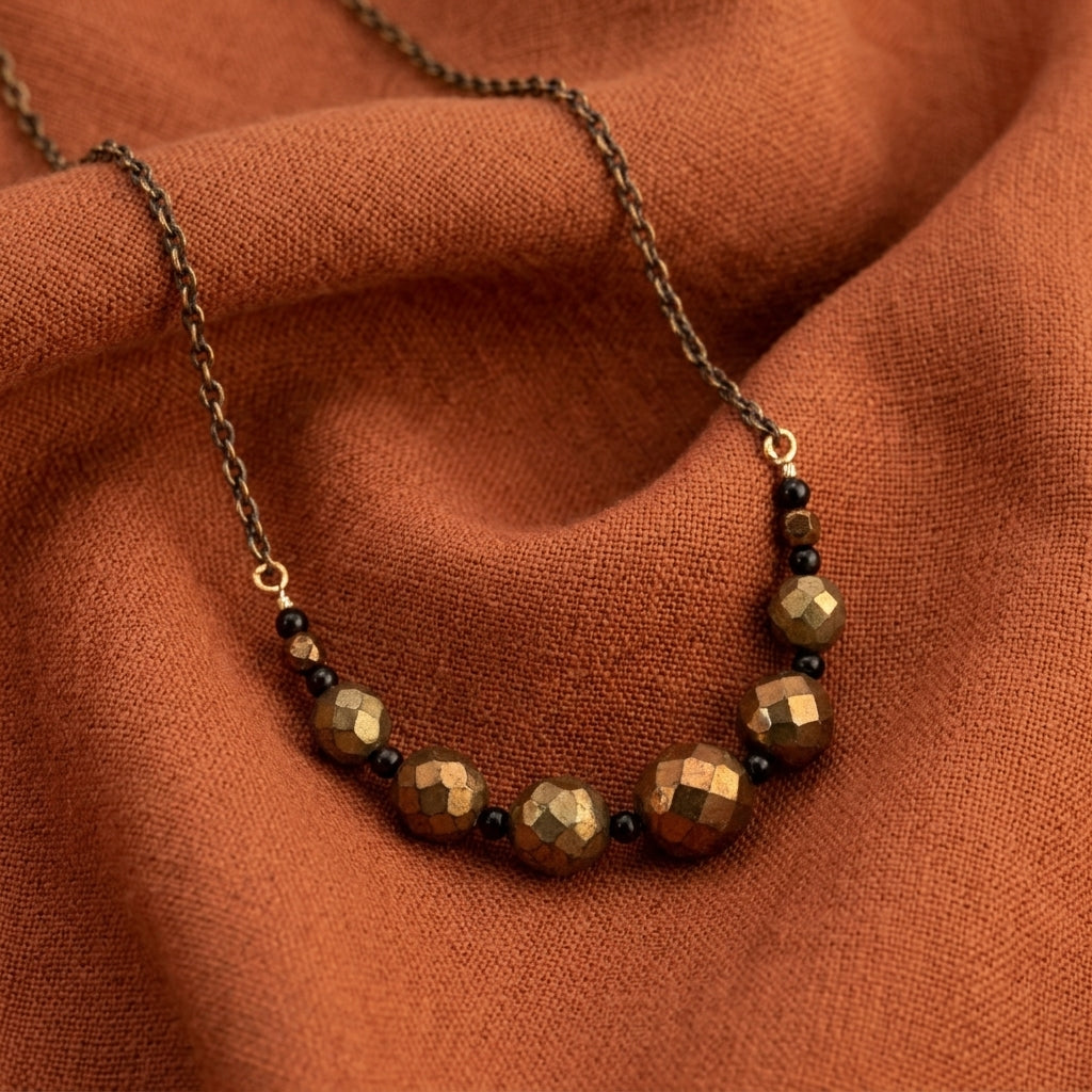 Necklace with brown beads on a rust-colored fabric background