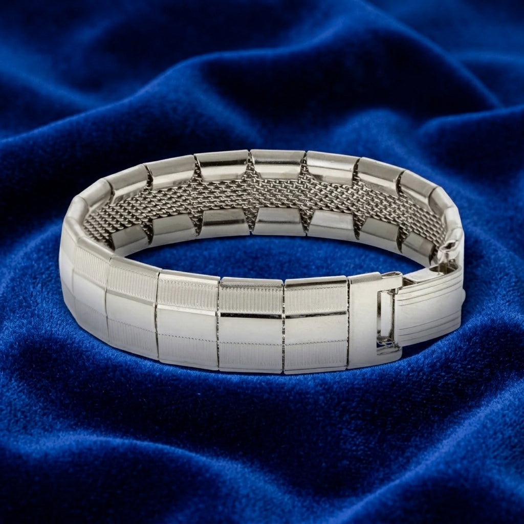 Silver bracelet on a blue fabric background
