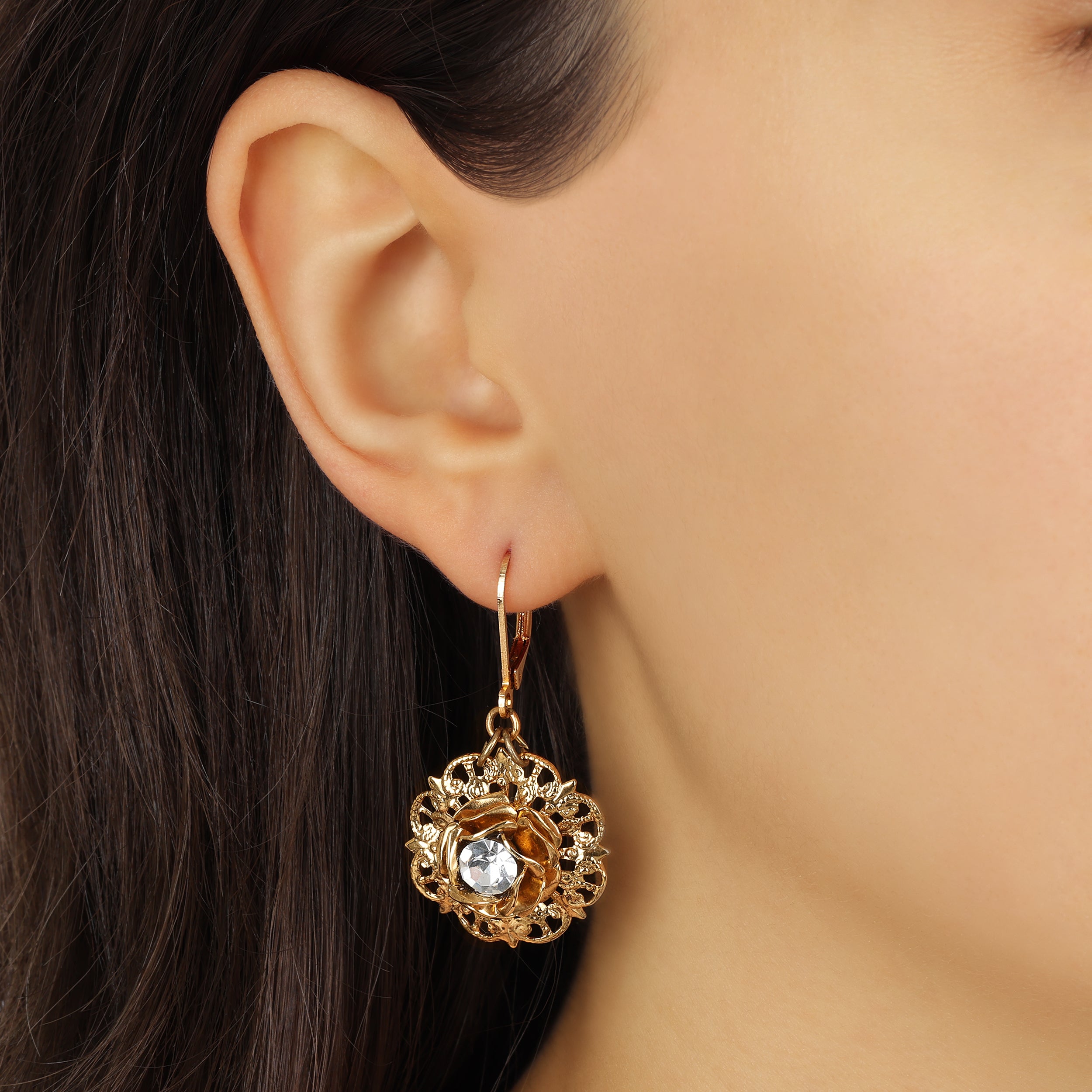 Close up of a woman wearing Golden Floral Filigree & Layered Rose Antique Drop Earrings