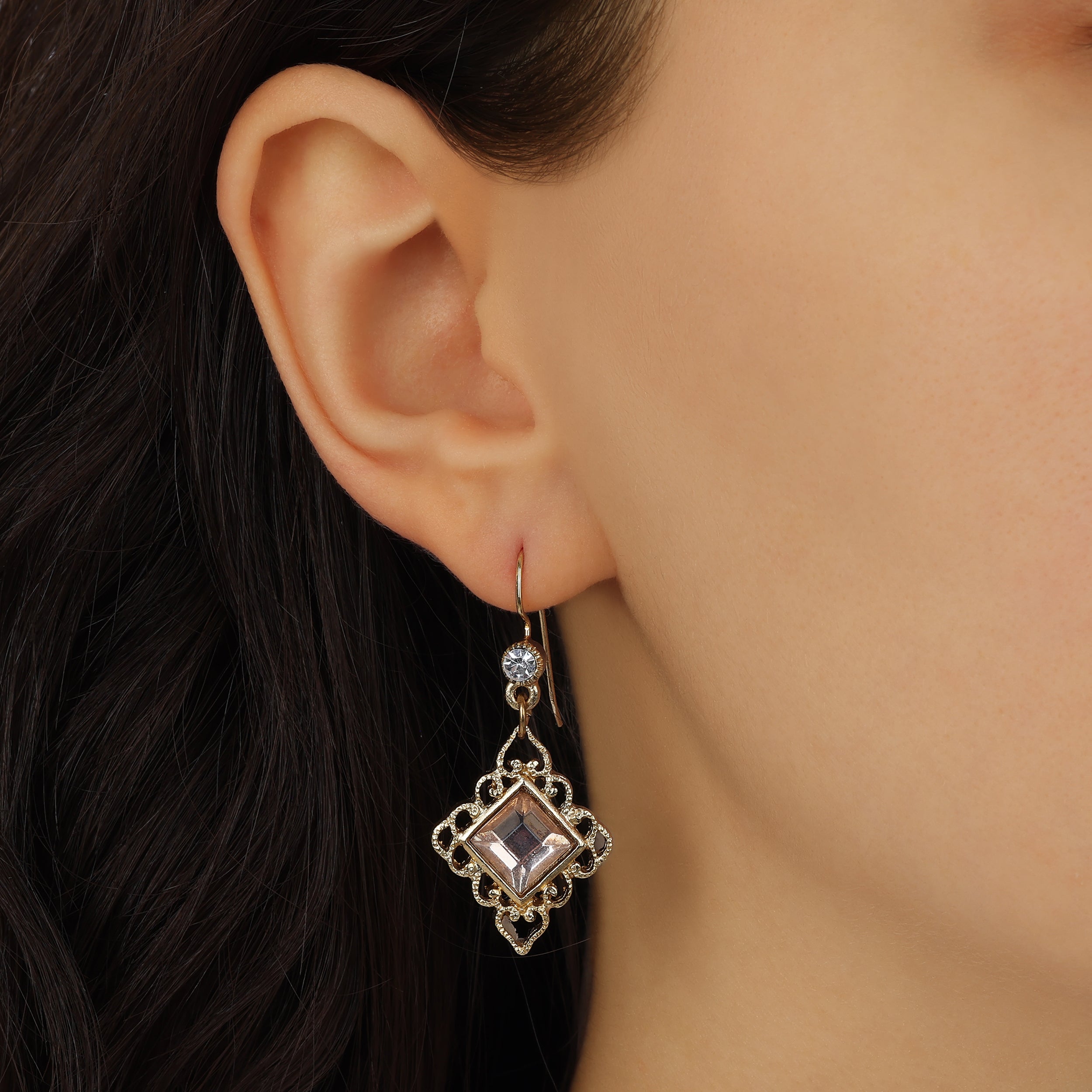 Close up of a woman model wearing Gold Filigree & Diamond Shaped Peach Crystal Drop Earrings