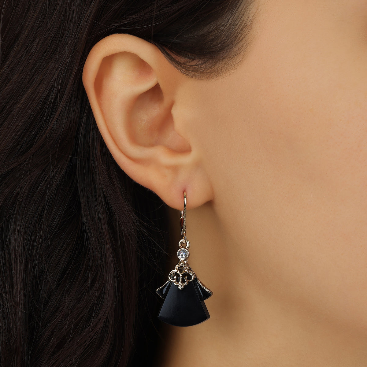 Close up of a woman model's ear wearing our Vintage Style Jet Black Flared Fan Drop Earrings