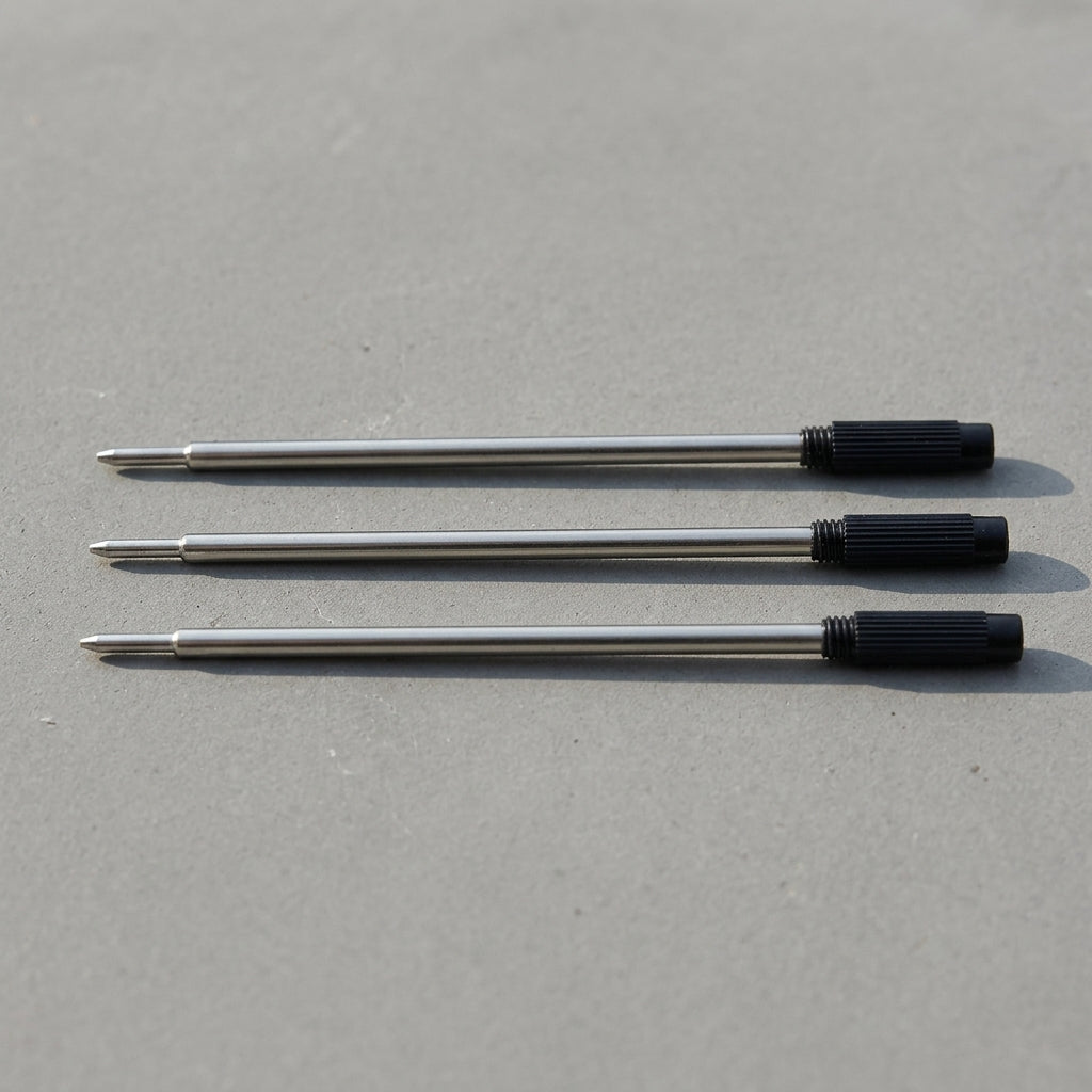 Set Of 3 Pen Black Refill Ink Cartridges resting on concrete surface
