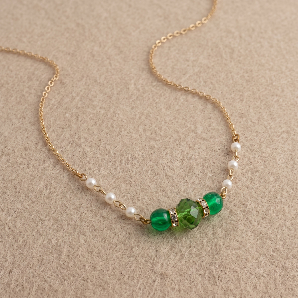Emerald Green Glass Beads & Faux Pearl Chain Necklace 15" + 3" Extension resting on beige felt