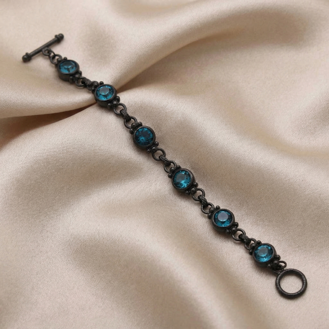 Bracelet with blue gemstones on a beige fabric background
