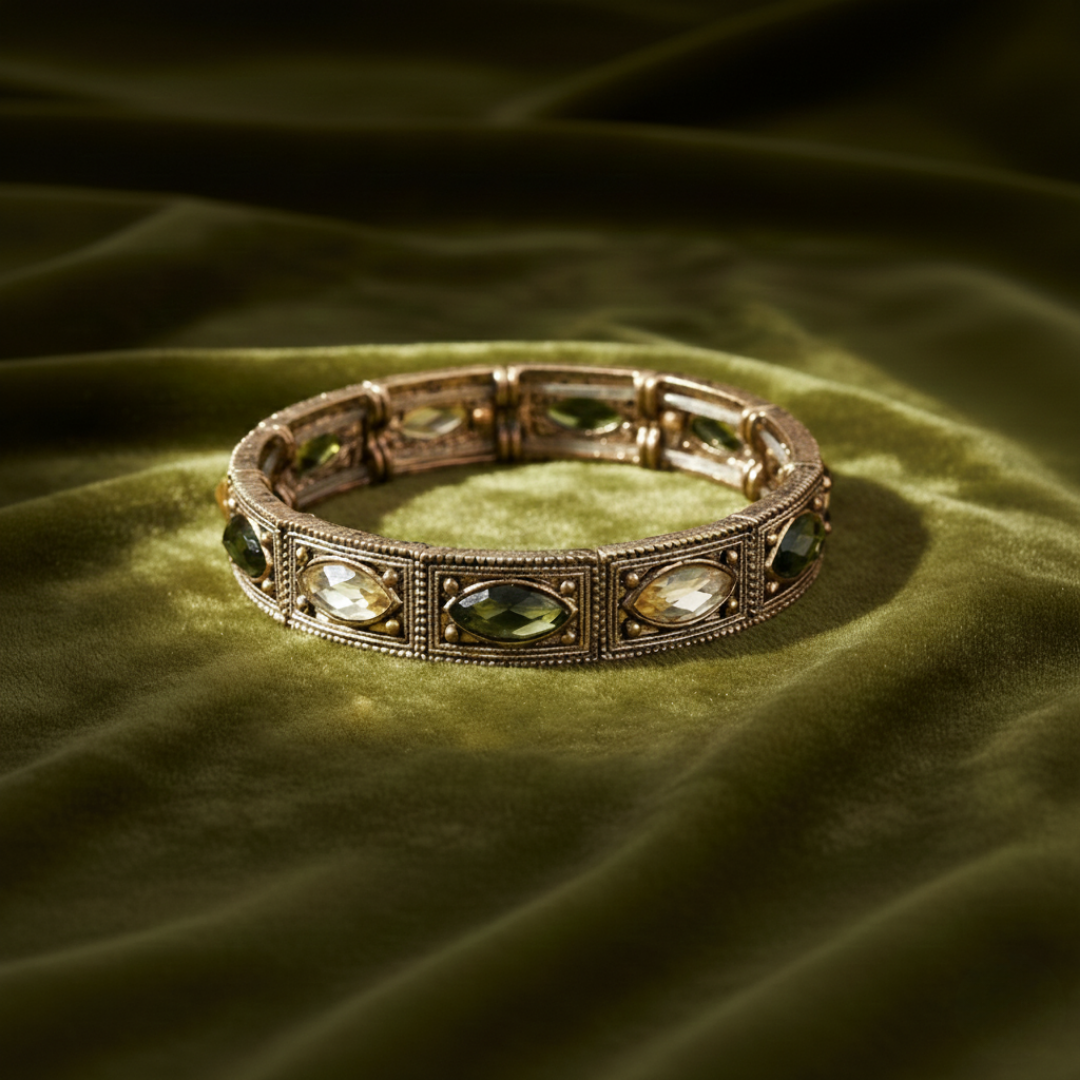 Decorative bracelet with gemstones on a green fabric background