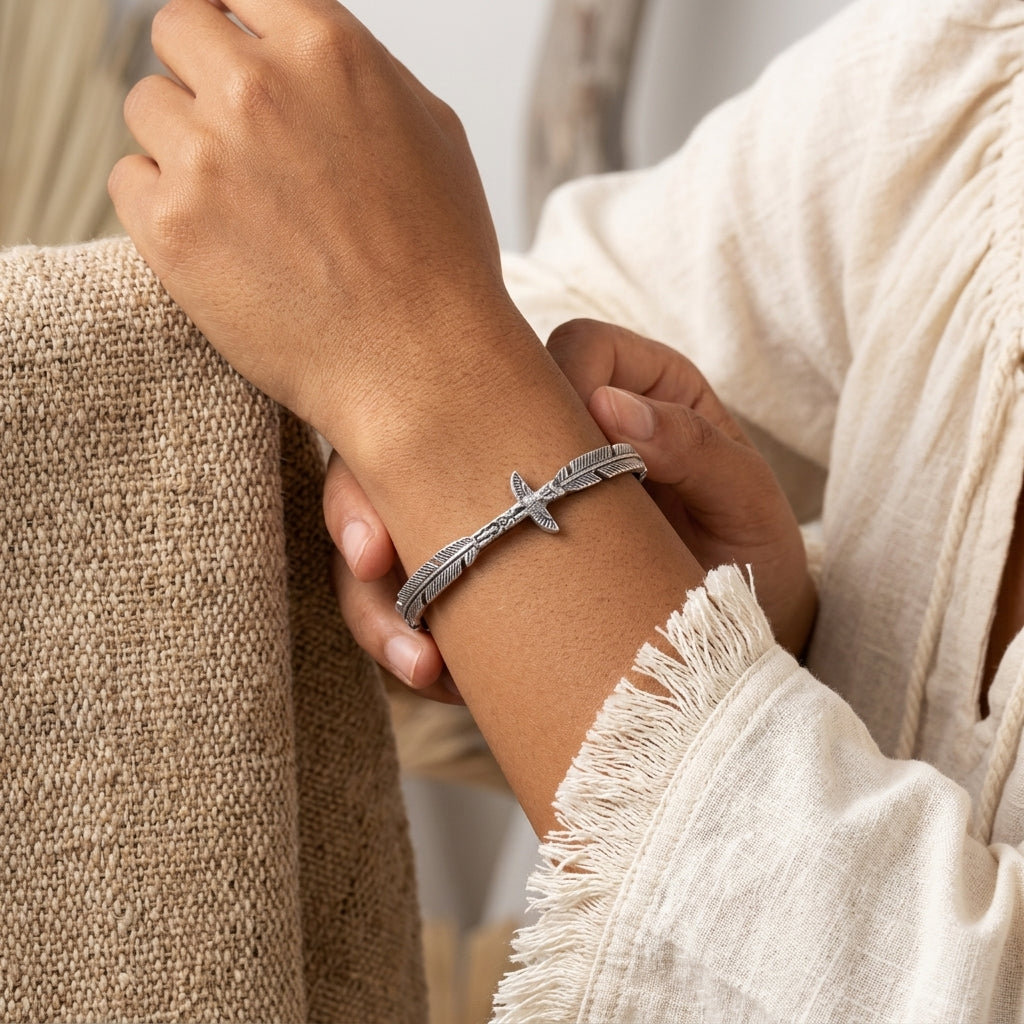 Pewter Totem Pole Feather Cuff Bracelet worn on a person's wrist.