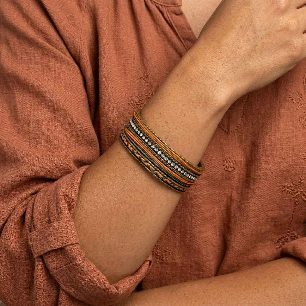A close-up of a person wearing a Waxed Linen & Rhinestone Bangle Bracelet
