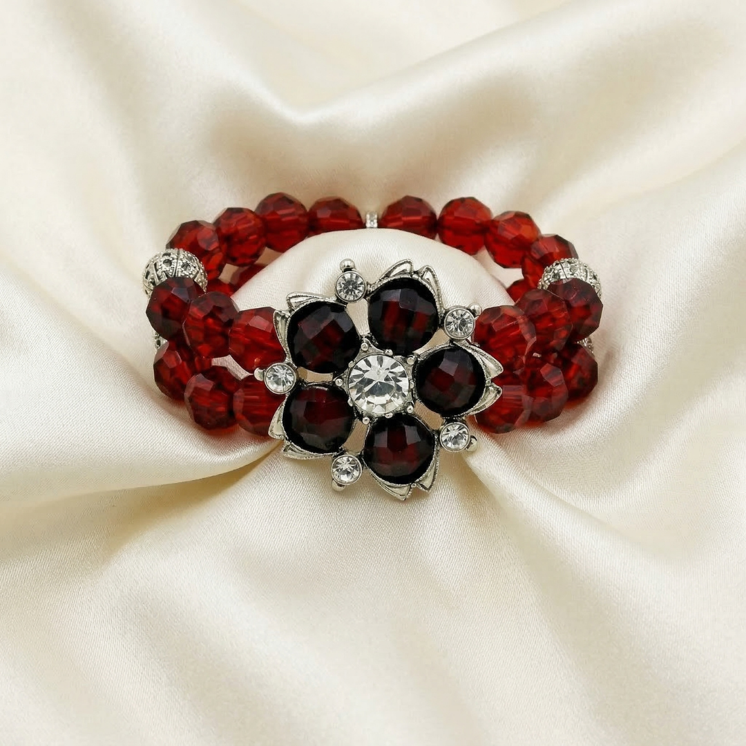 Bracelet with red and black beaded crystals on a beige fabric background