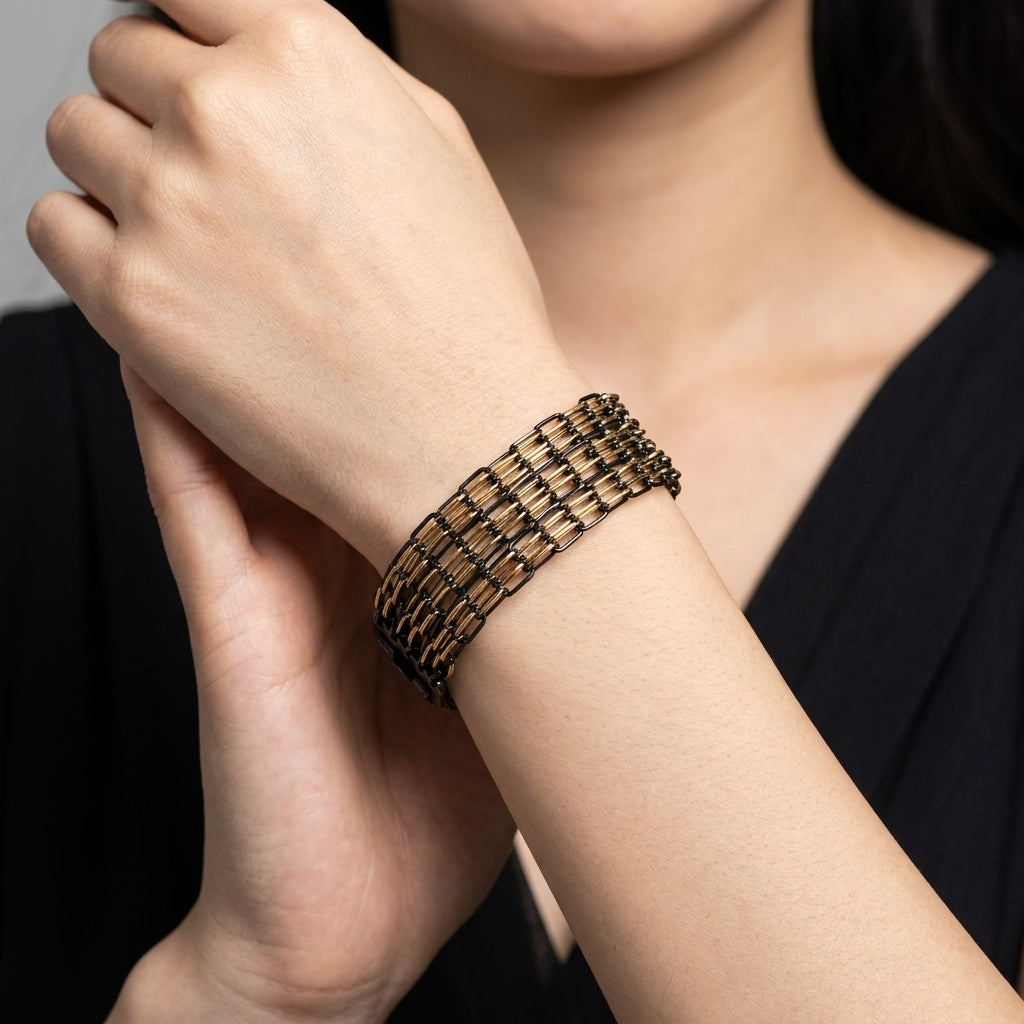 Eclipse Black And Gold Multi Chain Clasp Bracelet worn by a model in a black dress
