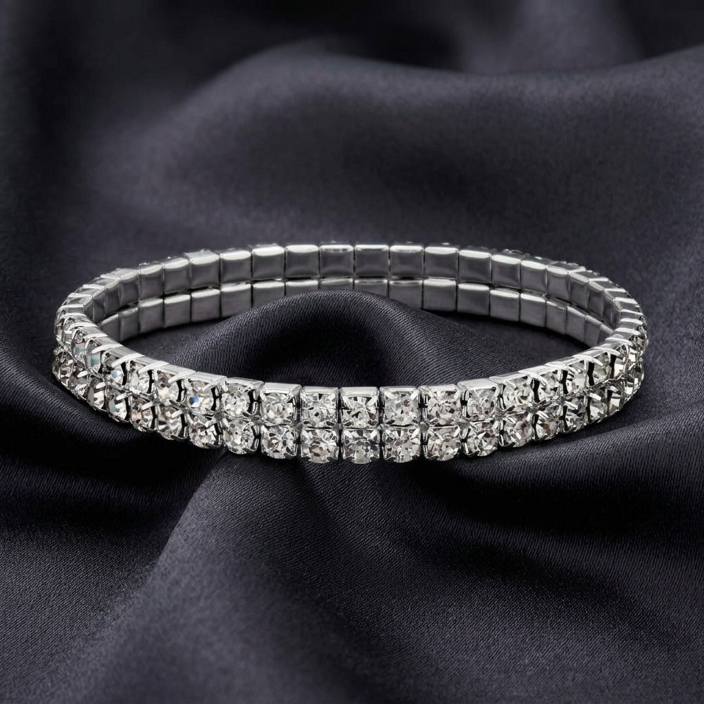Silver bracelet with clear crystals on a dark fabric background