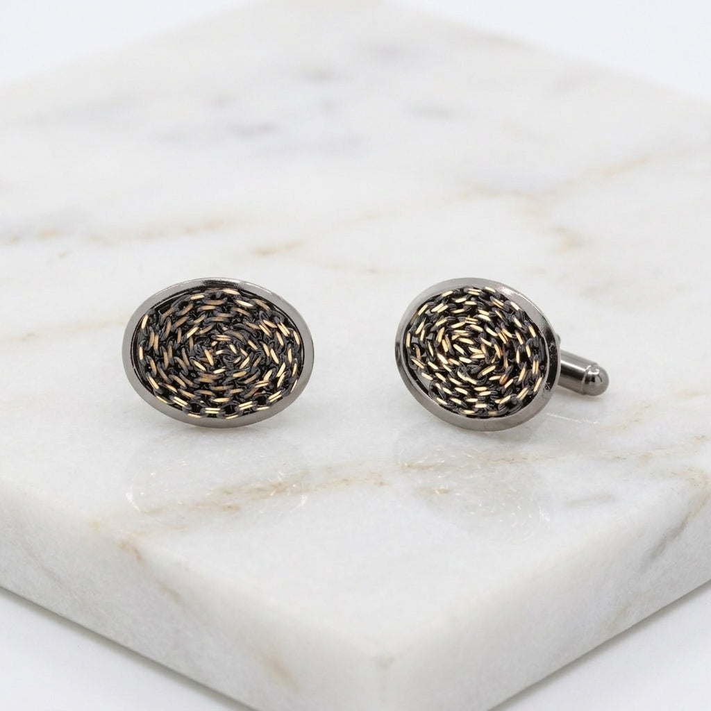 Eclipse Black And Gold Chain Cufflinks resting on white marble stone