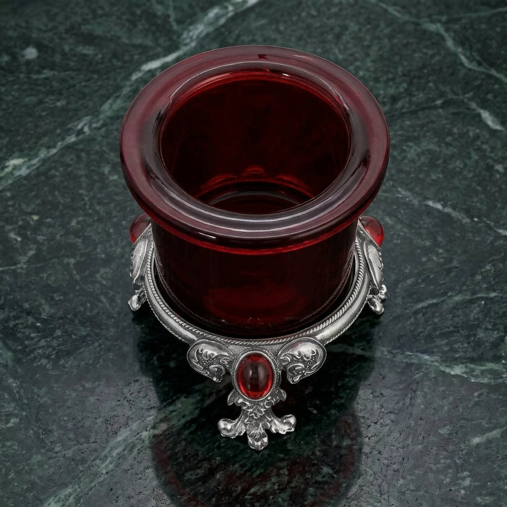 Pewter Votive Oval Red Stone Glass Candle Holder on a dark marble surface