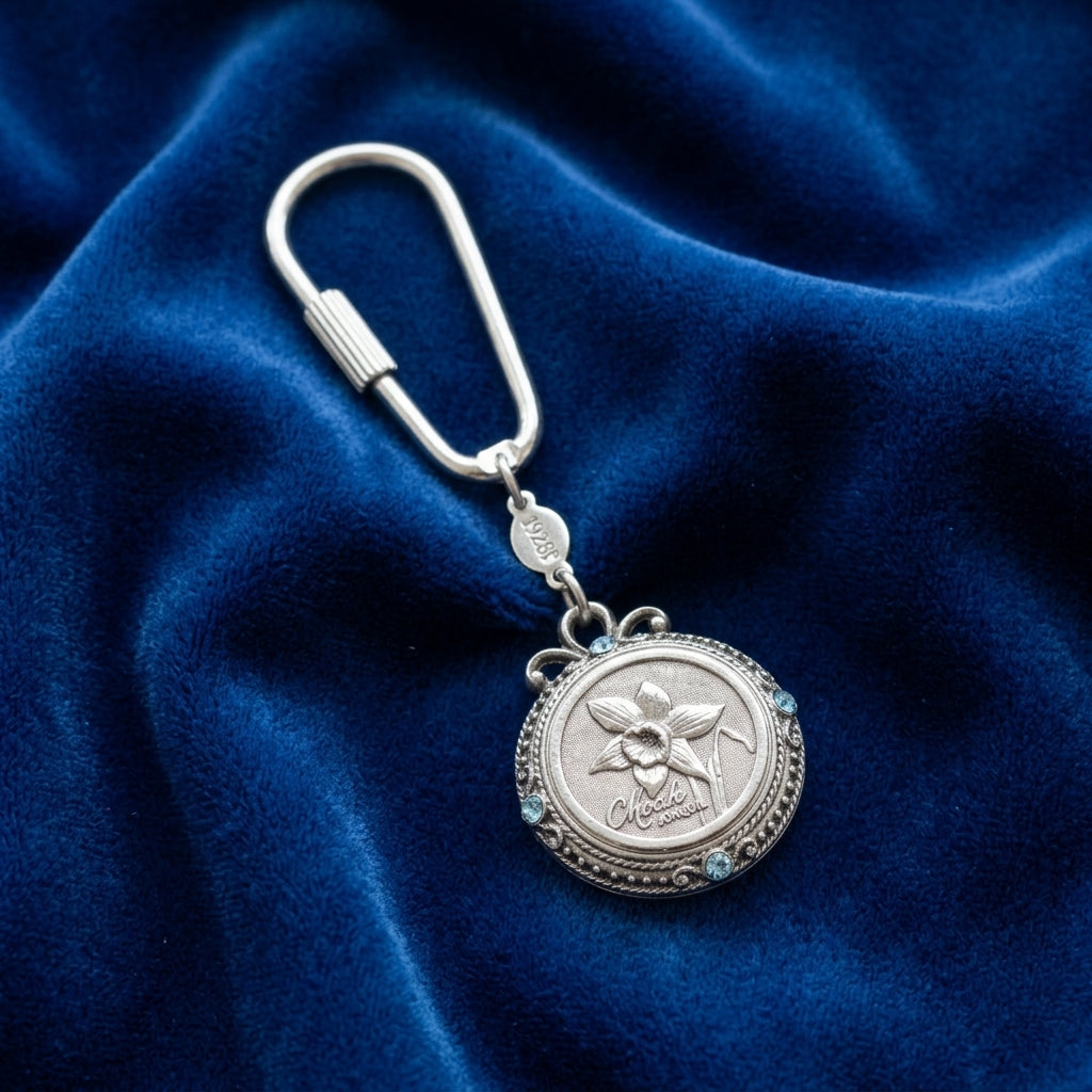 March Crystal Flower of The Month Carabiner Key Chain resting on a blue fabric background