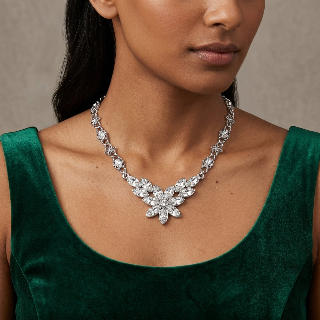 Woman wearing a sparkling crystal necklace against a neutral background