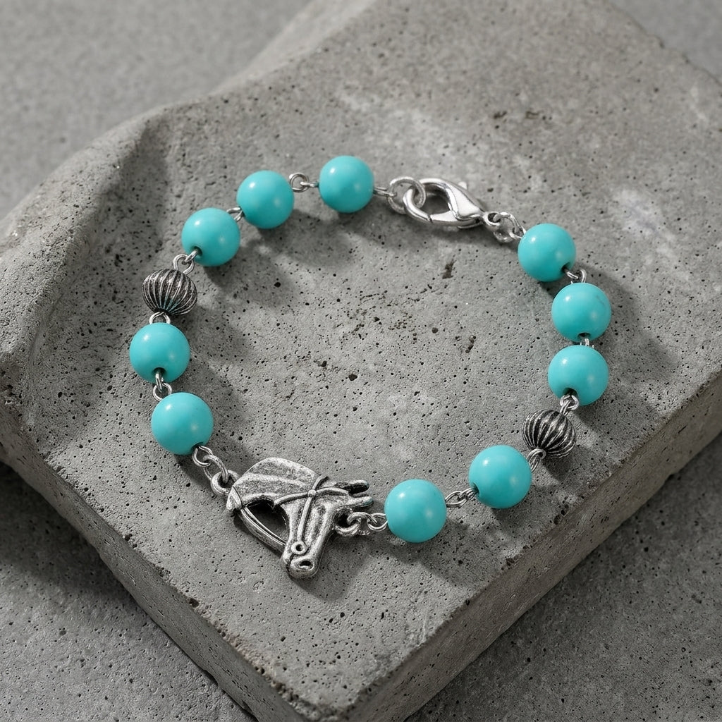 Southwest Turquoise Bead Horse Head Link Bracelet on a concrete surface