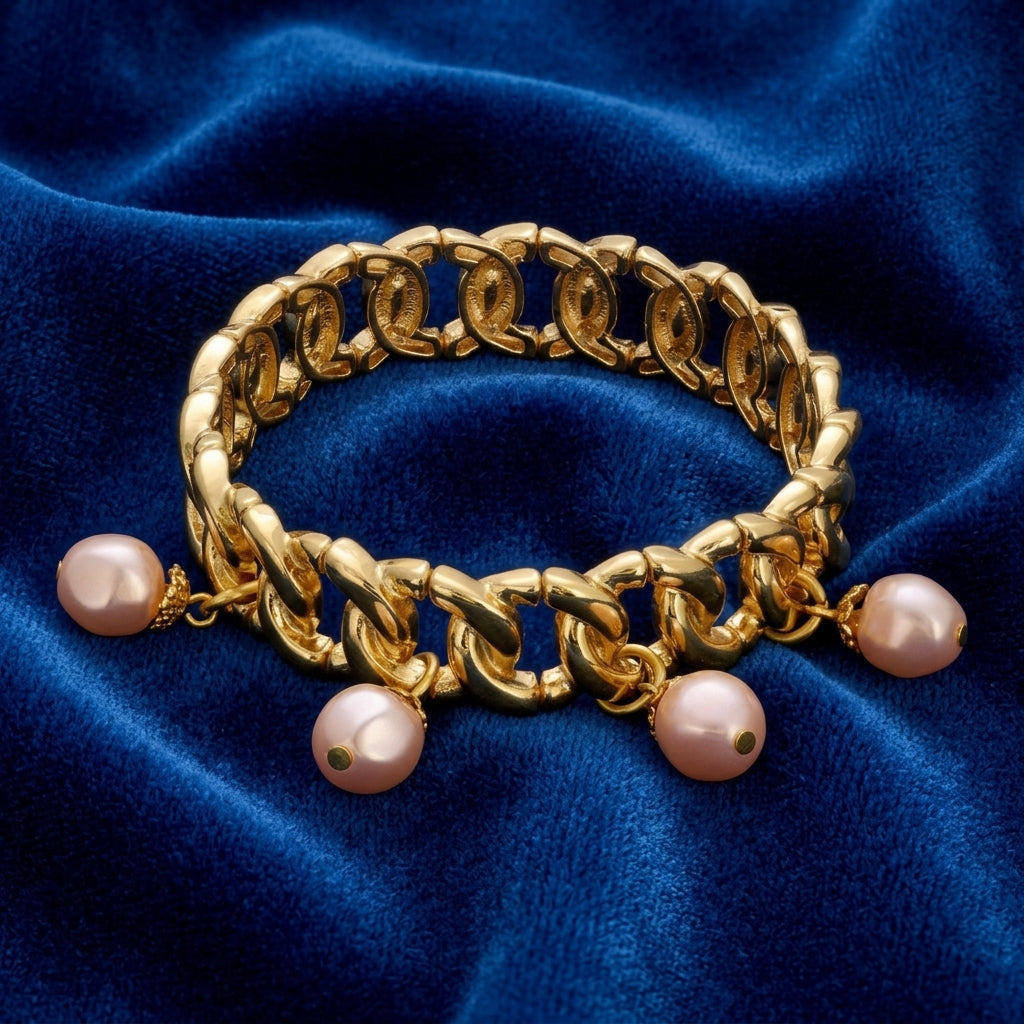 Gold tone pink Faux Pearl Drop Bead Stretch Bracelet on blue fabric