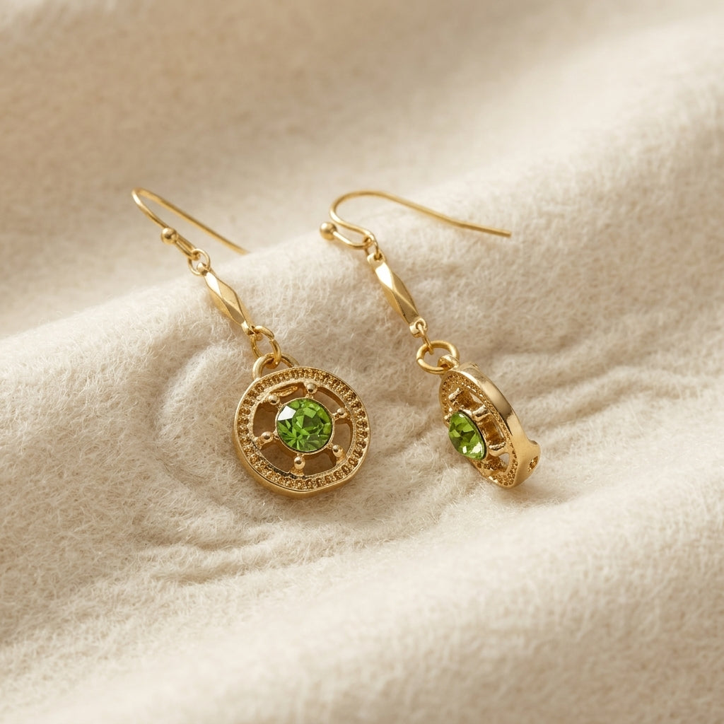 Round Ornate Light Green Crystal Dangle Earrings displayed on a soft beige textured fabric background.