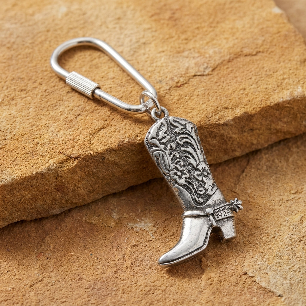 Pewter Cowboy Boot Carabiner Key Chain on a stone surface