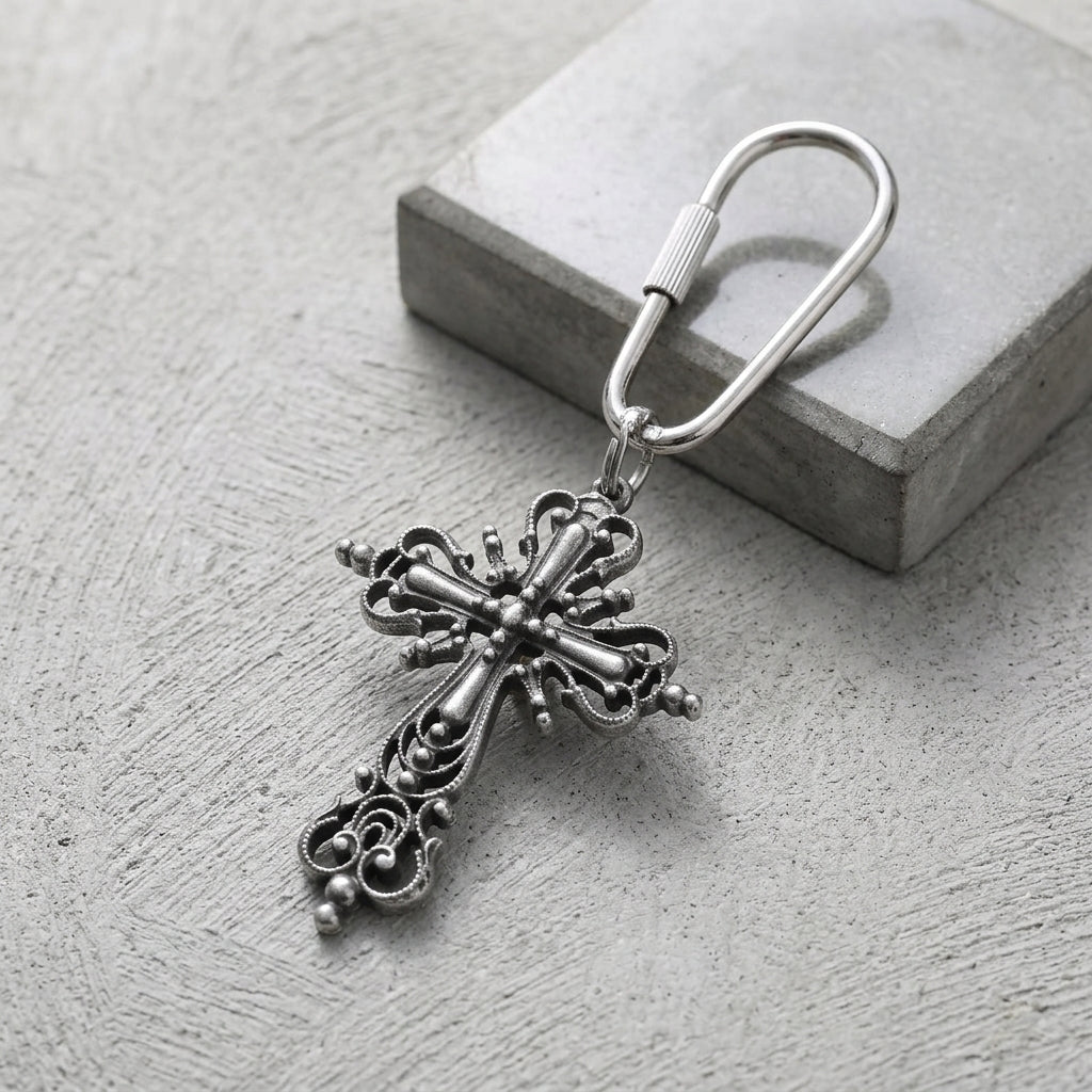 Classical silver tone Cross Carabiner Key Chain resting on a cement surface