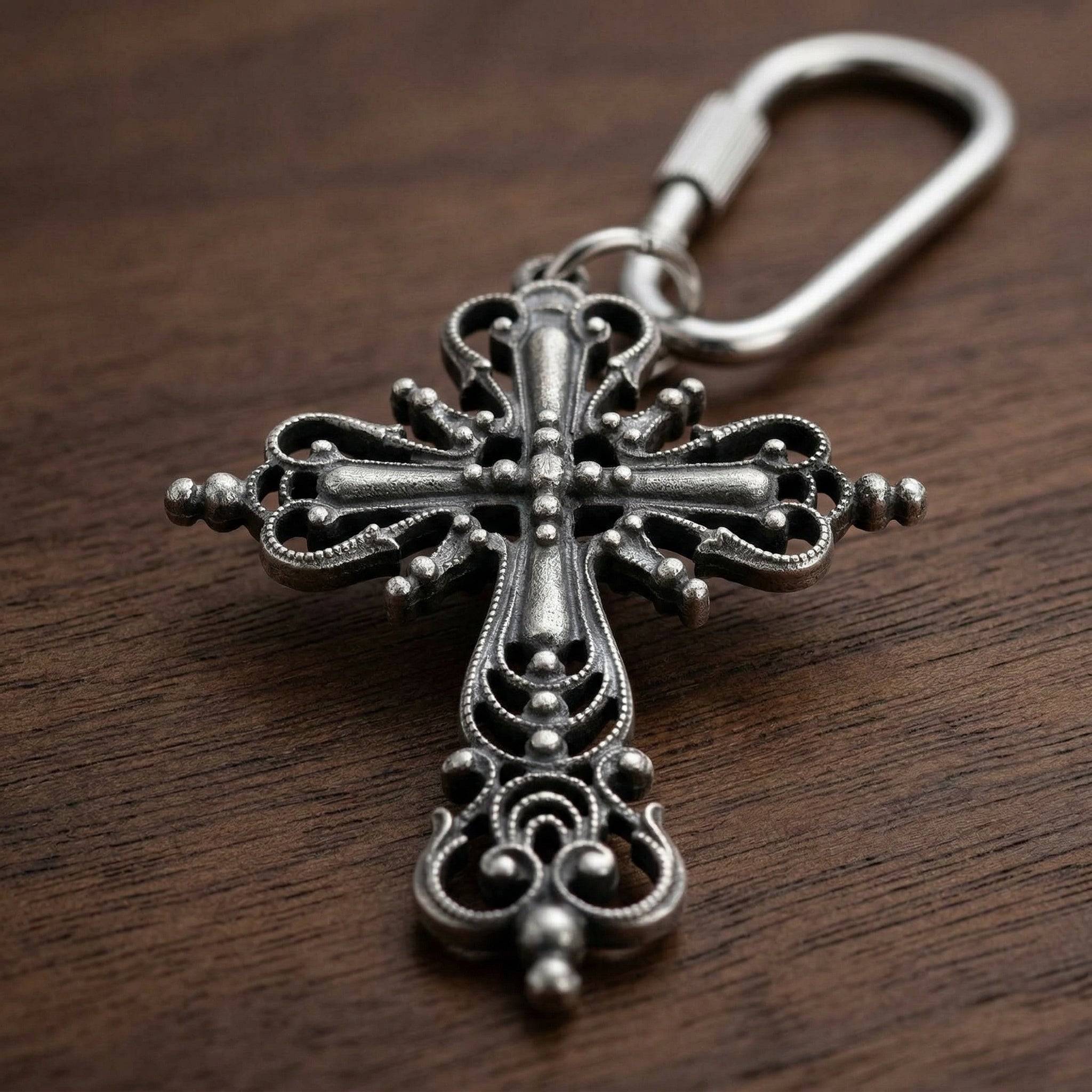 Classical silver tone Cross Carabiner Key Chain on a wooden surface