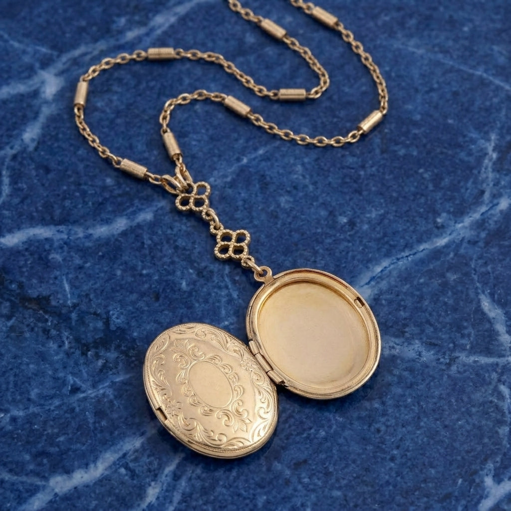 Opened gold tone Pre-Raphaelite Art Inspired Locket Necklace resting on blue marble stone