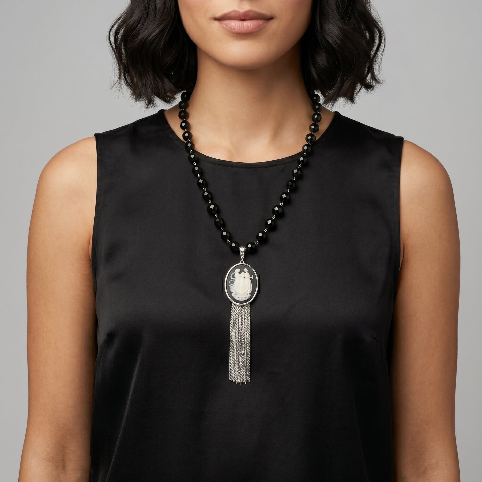 Woman wearing a black beaded Grecian Women & Water Pitcher Cameo Pendant Tassel Necklace