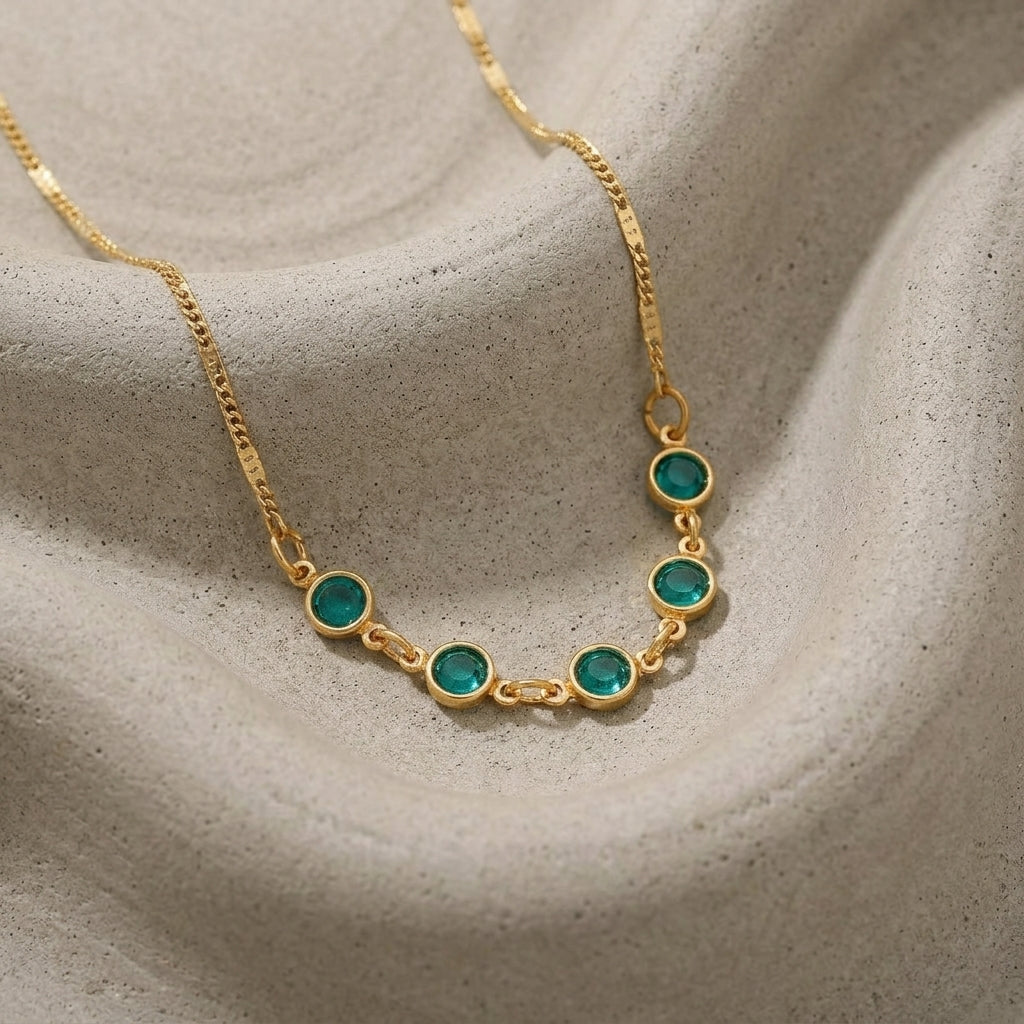 Emerald Green European Crystal Channel Necklace on a textured beige surface