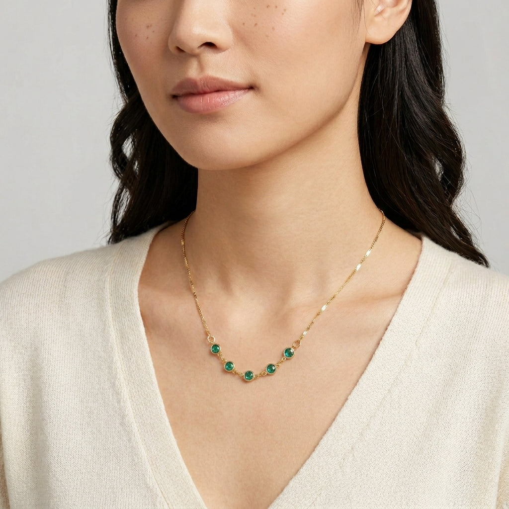 Woman wearing a gold tone Emerald Green European Crystal Channel Necklace