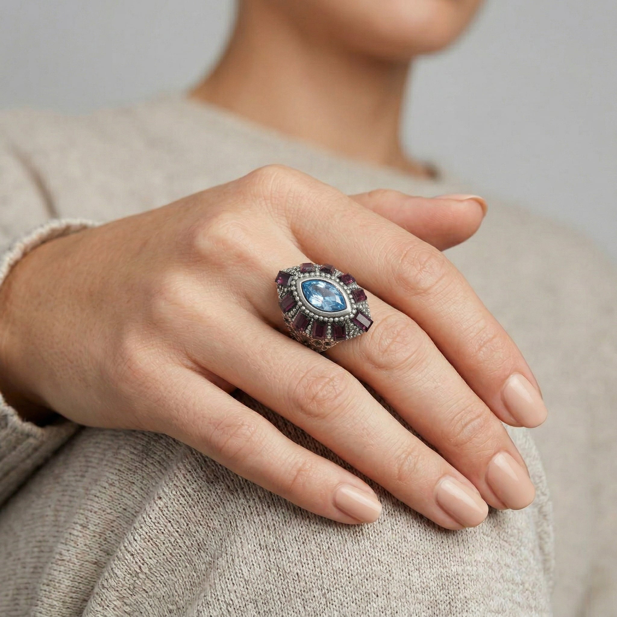 Hand wearing a decorative Honora Hammered Purple & Light Sapphire Crystal Ring