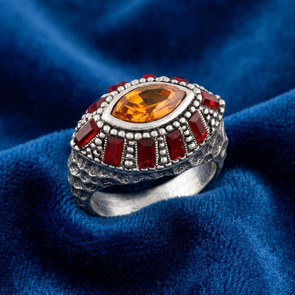 Honora Hammered Siam Red & Topaz Crystal Ring on a blue fabric background
