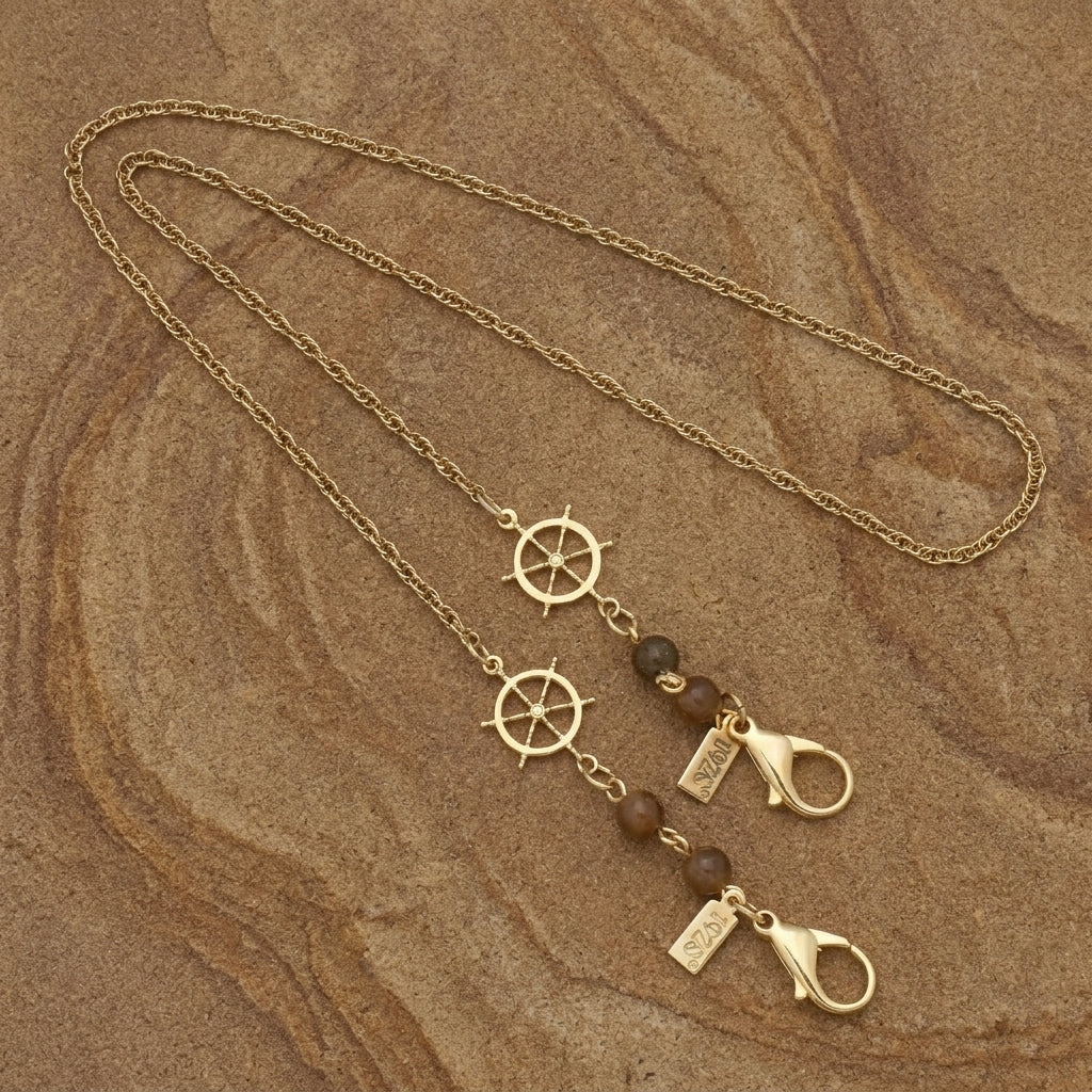 Gold Ship Wheel Tortoise Brown Bead Face Mask Holder on a brown stone surface