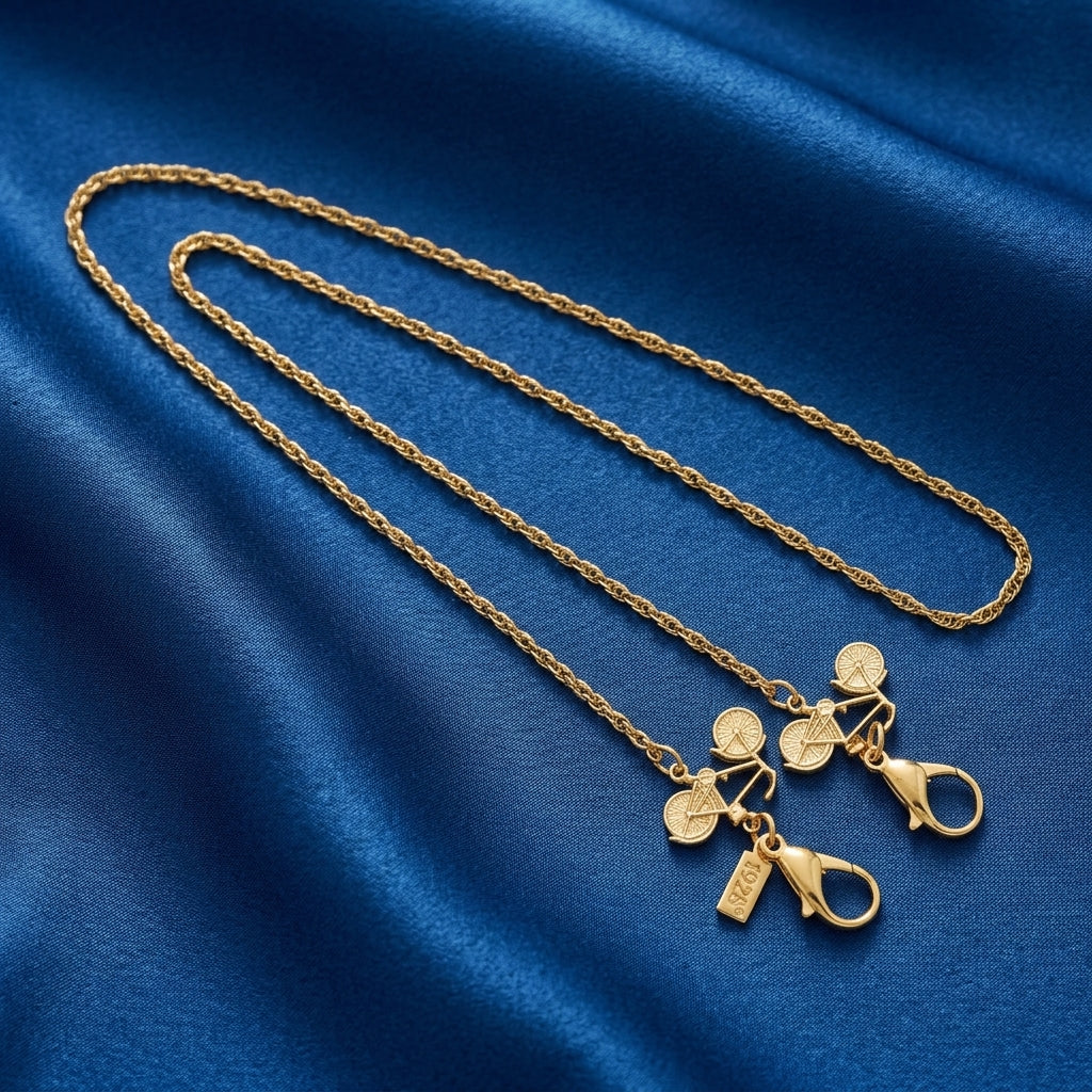 Gold Bicycle Face Mask Chain Holder on a blue fabric background