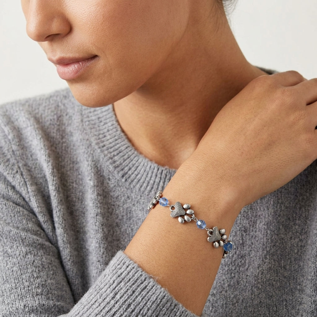 Woman wearing a bracelet with Paws & Light Sapphire Blue Glass Beads