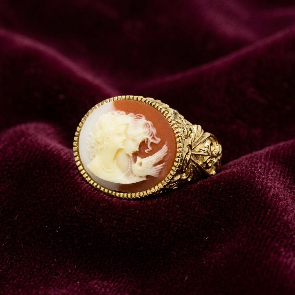Gold tone ring with a cameo design on a purple velvet background