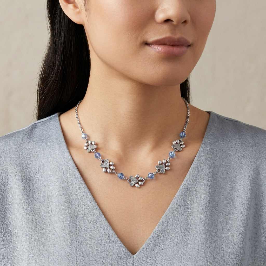 Light Blue Sapphire Bead Pewter Paw Necklace worn by a person against a neutral background