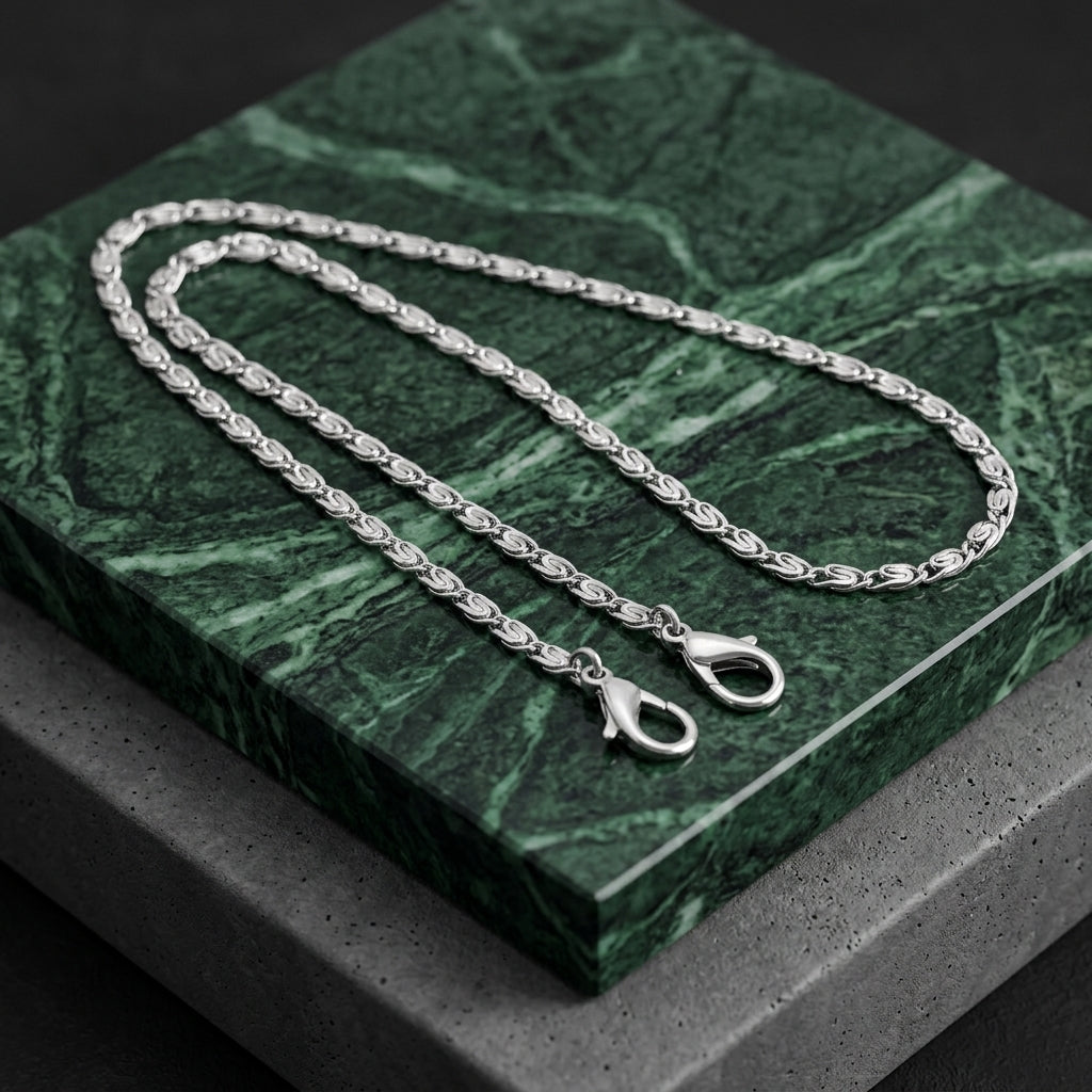 Silver tone Classy Link Face Mask Chain Holder resting on green marble
