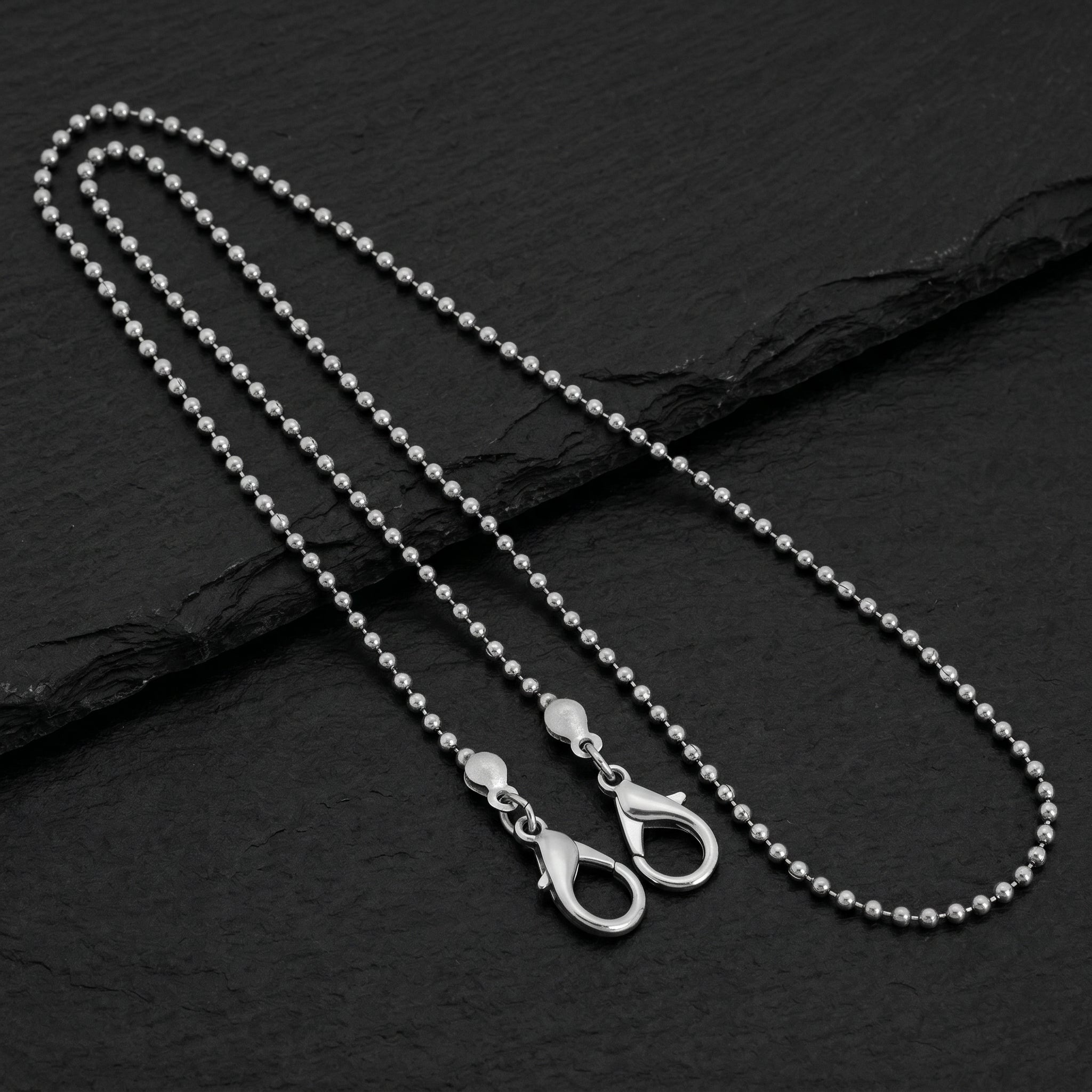 Stainless Steel 2.4 mm Ball Chain Mask Holder with a clasp on a black stone surface