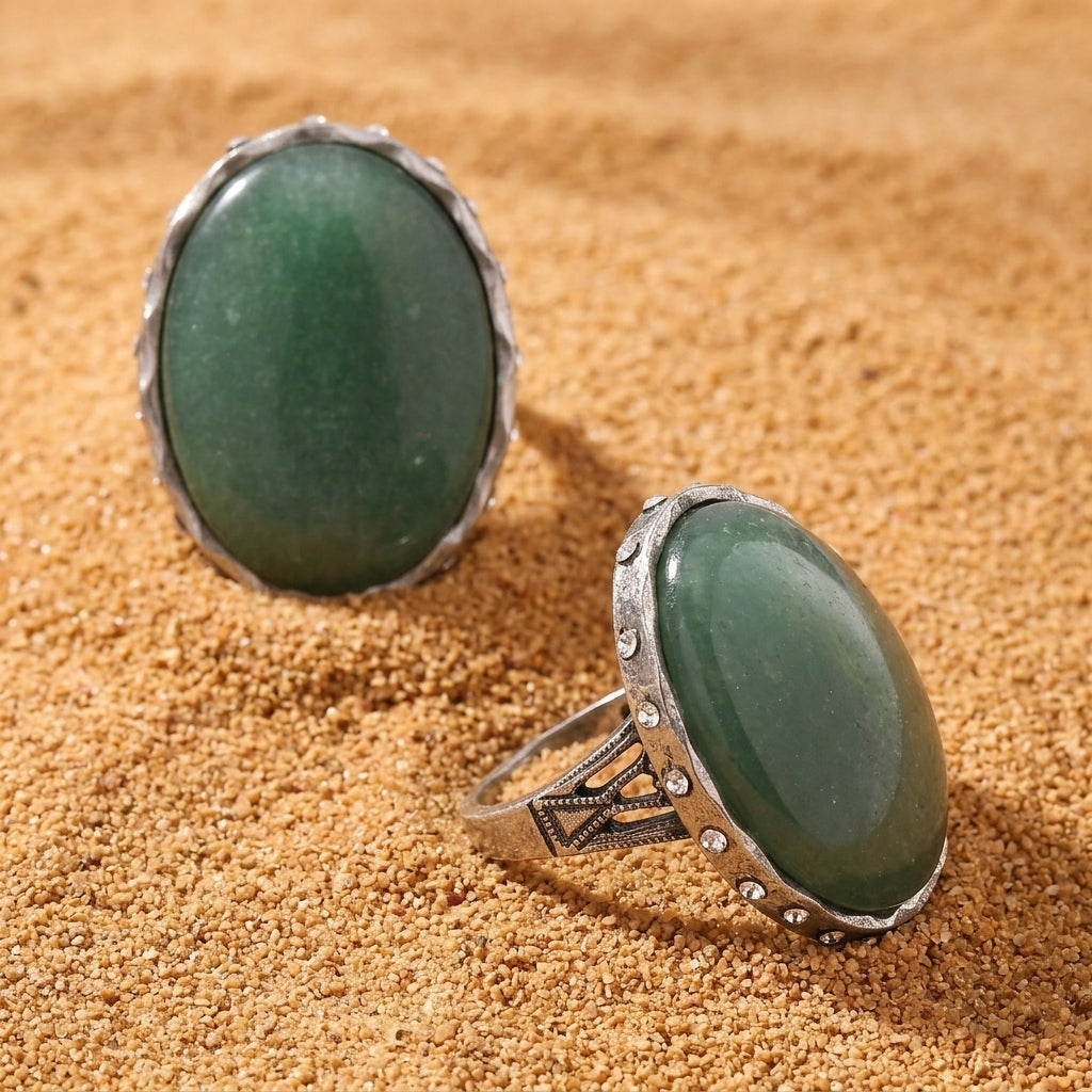 Green Aventurine Gemstone Austrian Crystal Oval Ring on a sandy surface