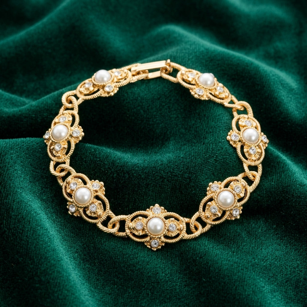 Gold tone Prestige Textured Link Crystal And Stone Bracelet on a green fabric background