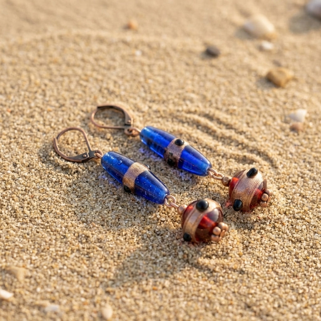 Bohemian Sapphire Blue & Brown Bead Dangle Earrings on a sandy surface