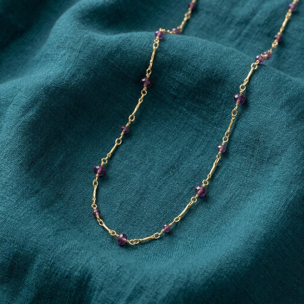Purple Beaded Chain Necklace on a teal fabric background