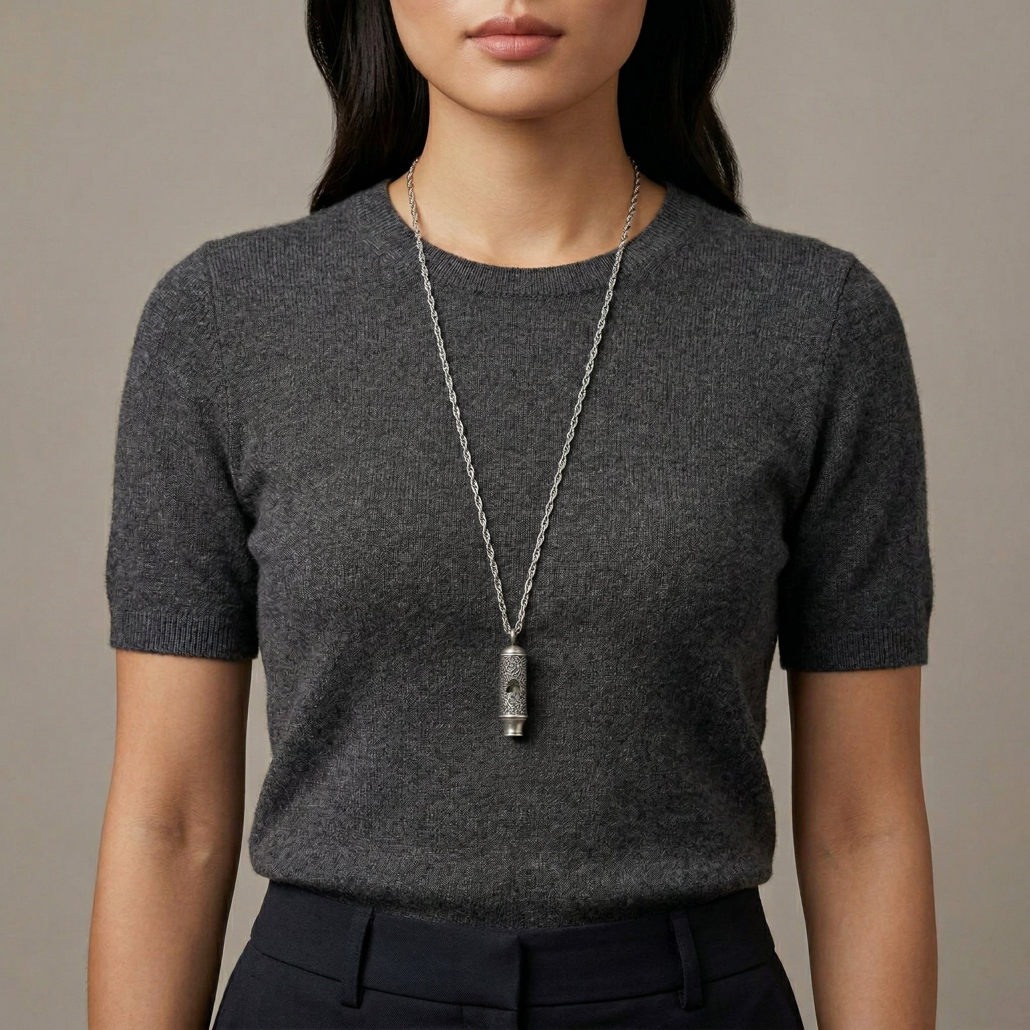 Woman in a dark outfit wearing a Lesser Celandine Flower Whistle Pendant Necklace