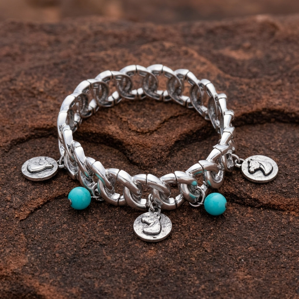 Horse Head Charms Turquoise Bead Stretch Bracelet on a textured brown stone surface