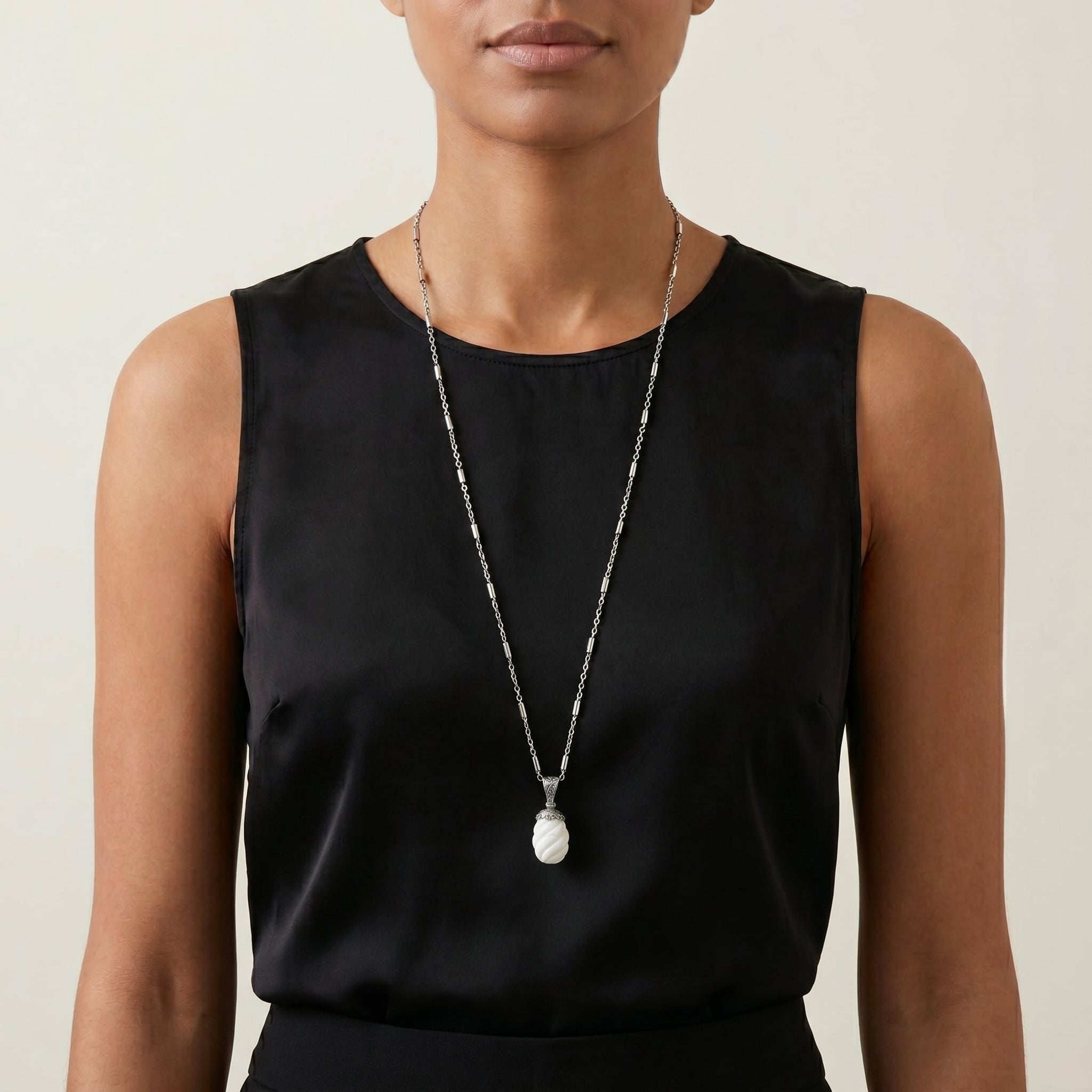 White Gemstone Bead Pendant Necklace worn by a woman in a black sleeveless top