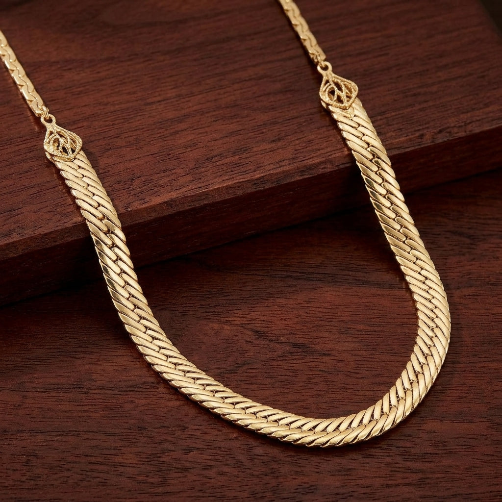 Gold necklace on a dark wooden surface