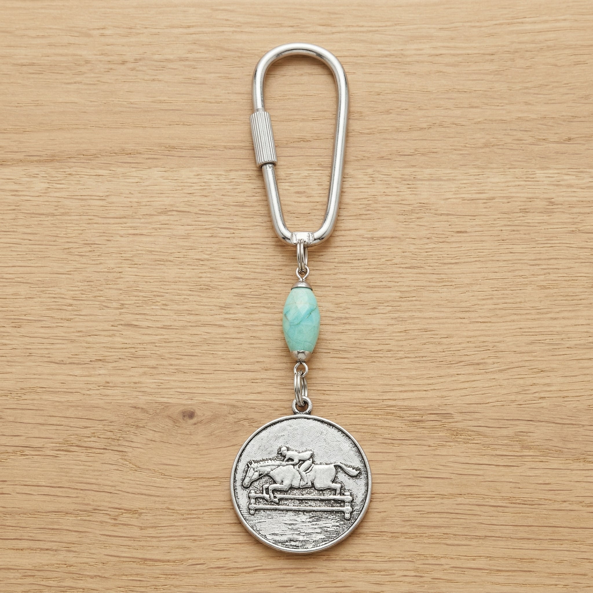 Turquoise Gemstone Bead Horseback Rider Carabiner Key Chain on wooden surface