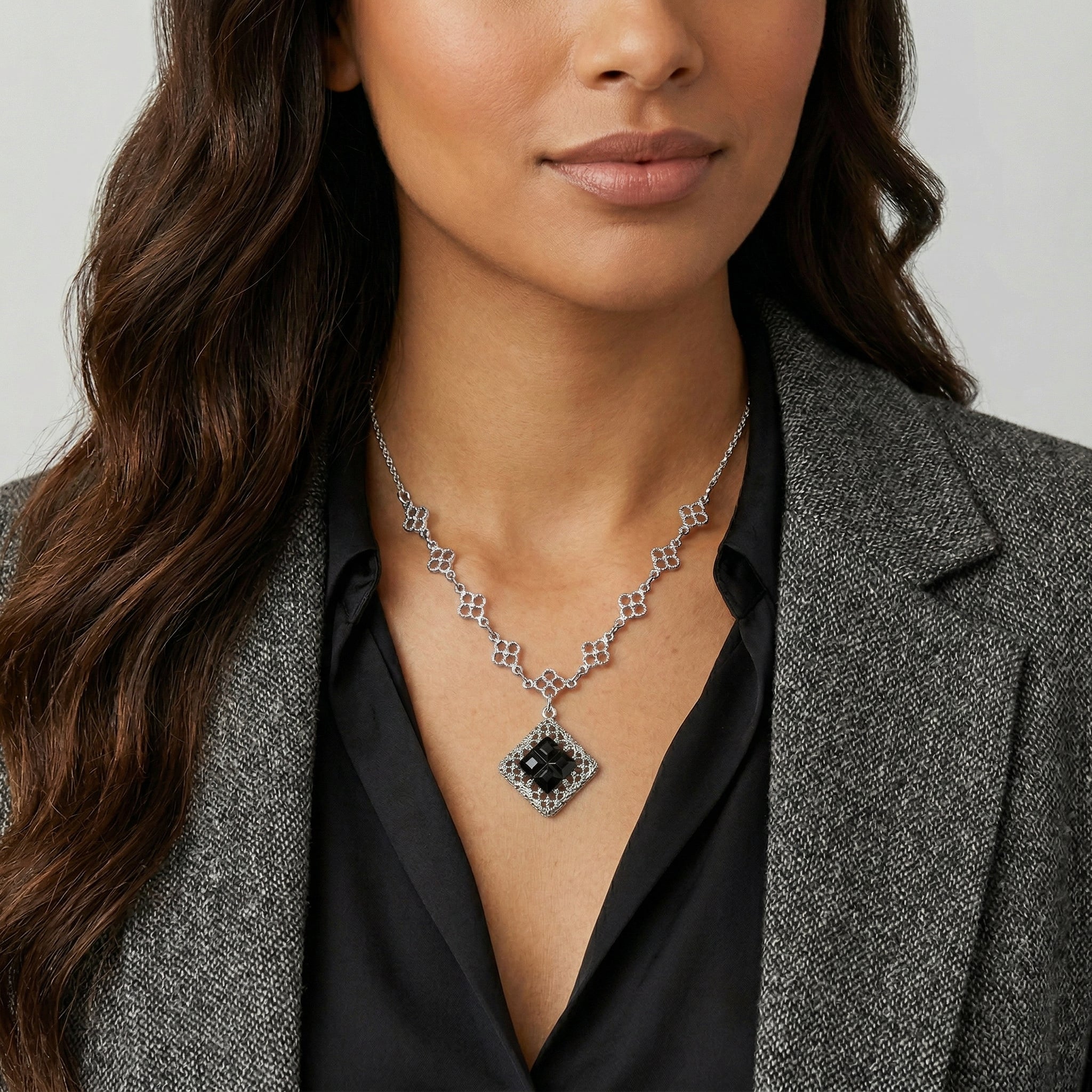 Woman in a blazer wearing a Belladonna Black Glass Stone Filigree Pendant Necklace
